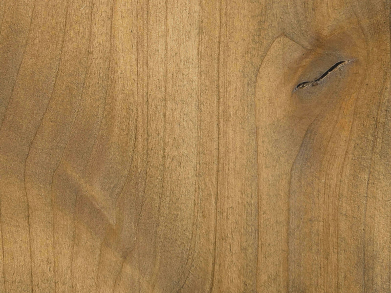 Close-up of the Nora Buffet - Harvest Wheat by James+James showing a grainy texture with natural variations in color from light to medium brown. There's a dark knot near the upper right corner, adding character and interest to the wood's appearance.