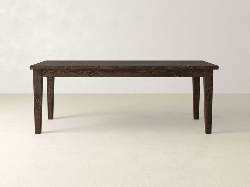 The Ava Parsons Dining Table - Tobacco by James+James is a simple wooden dining table featuring a dark brown finish. It has a rectangular top and four straight legs, set against a plain light-colored background with no additional items or decorations in the scene.