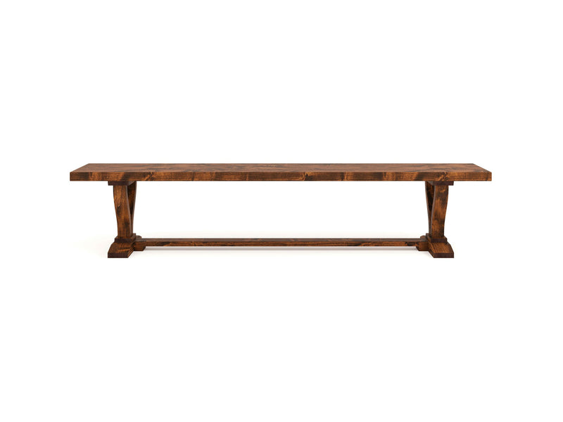 The Vera Bench - Tuscany by James+James features a classic, rustic design with a long rectangular seat and two sturdy pedestal legs connected by a horizontal support beam. Made from dark-stained wood, this bench sits beautifully against a white background.