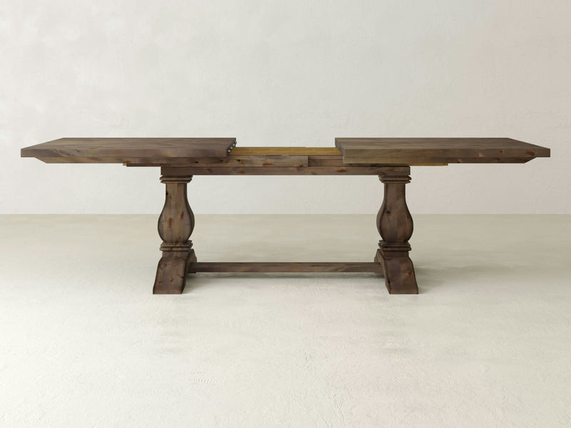 A close-up of the Heirloom Expandable Dining Table - Barn Wood by James+James.