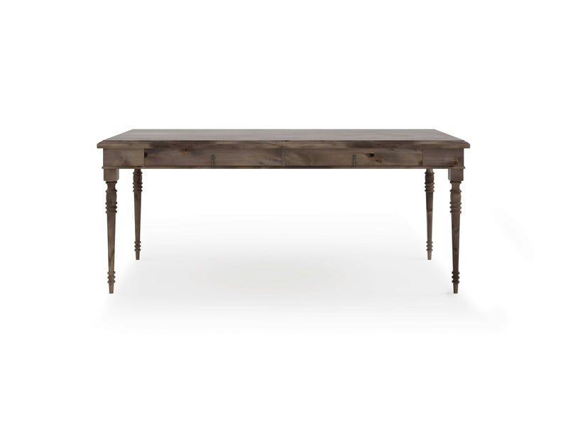 The Audrey Desk - Barn Wood by James+James is a rectangular wooden table with a rustic finish, featuring four elegantly turned legs. The table boasts a simple design without any additional decorations or carvings. It is photographed against a plain white background.