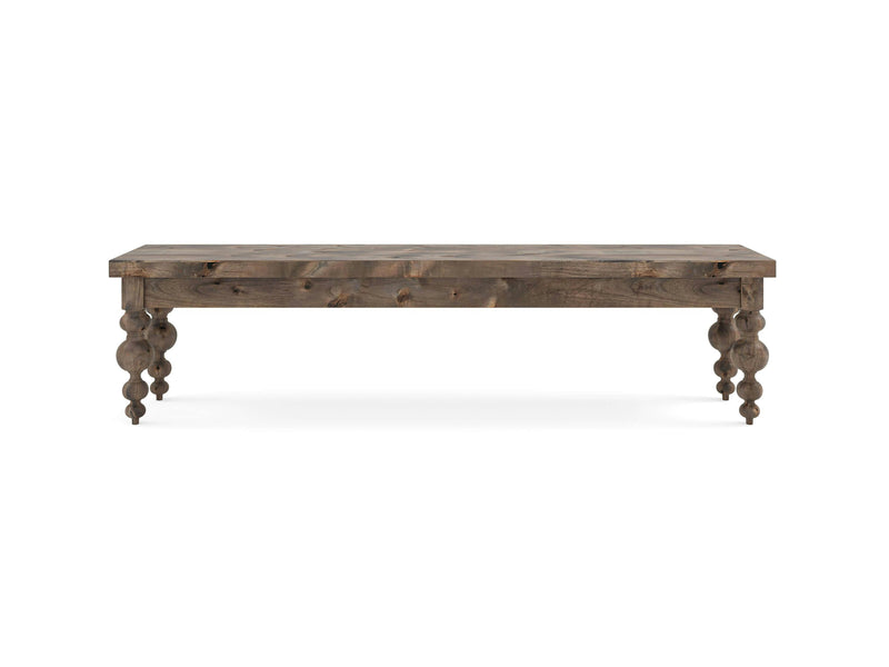 Introducing the Olivia Bench by James+James, meticulously crafted from barn wood. This bench boasts a rustic finish and intricately carved legs, embodying a classic style. The rectangular seating surface showcases visible wood grain patterns, while the ornate, rounded supports taper gracefully towards the base.