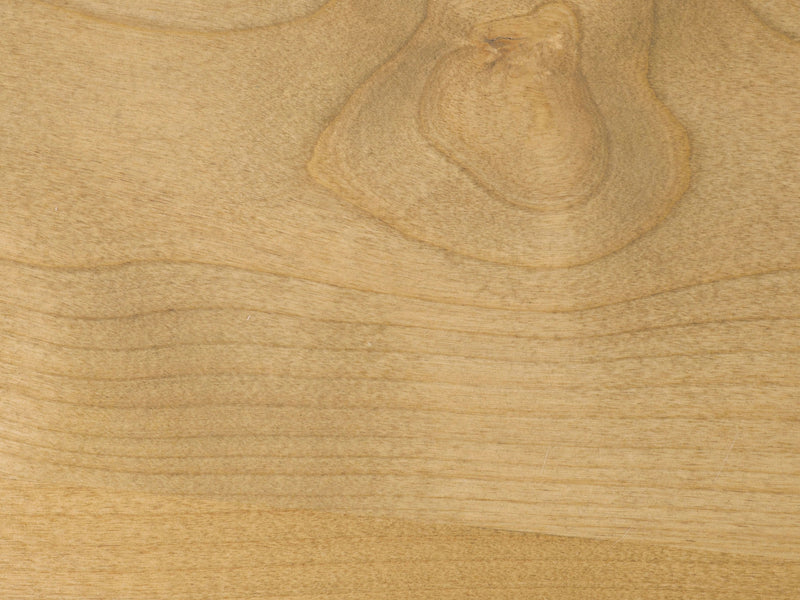 Close-up of the Satin on Alder Sample by James+James, showcasing a light-colored wooden surface with natural grain patterns and knots. The texture distinctly highlights the annual growth rings and features a prominent knot in the upper third of the image, adding character to the wood.