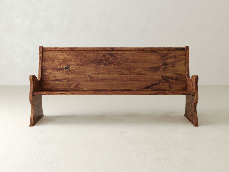 A close-up view of the Rustic Church Pew Bench - Tuscany by James+James reveals a wooden surface with a prominent knot in the center. The wood grain showcases varying shades of brown with a smooth, polished texture. The knot's visible cracks add character to the natural pattern of this beautifully crafted bench.