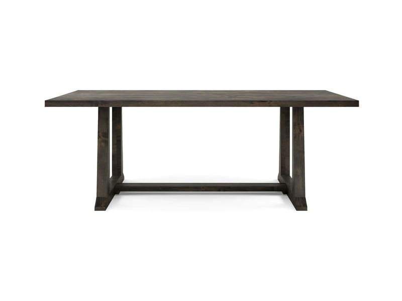 The Cora Dining Table - Deep Grey by James+James is a dark wooden rectangular table with a minimalist design. It features a flat tabletop and four sturdy legs connecting horizontally near the ground, forming an H-shaped support structure, giving it a modern and sleek appearance.