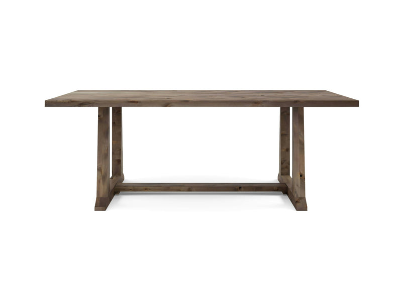 The Cora Dining Table - Barn Wood by James+James is a rectangular wooden table featuring a sturdy, simple design. Its flat plank top and trestle-style base give it a rustic and minimalist appearance. The natural finish of the wood showcases its grain and texture beautifully, all set against a plain white background.