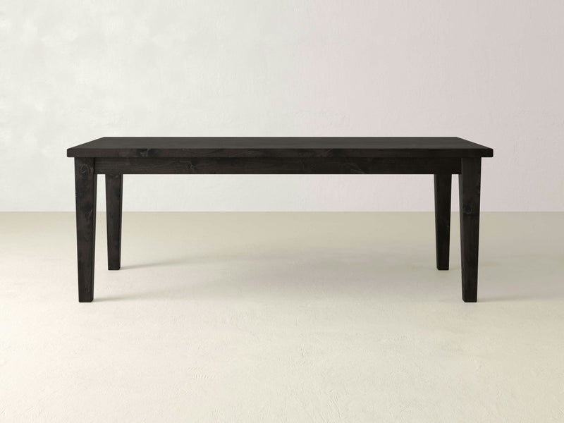 Product Description:
The Ava Parsons Dining Table - Charred Ember from James+James features a minimalistic design with clean lines and a smooth surface. This simple, rectangular black wooden dining table is fitted with four straight legs and is set against a plain, light grey background.