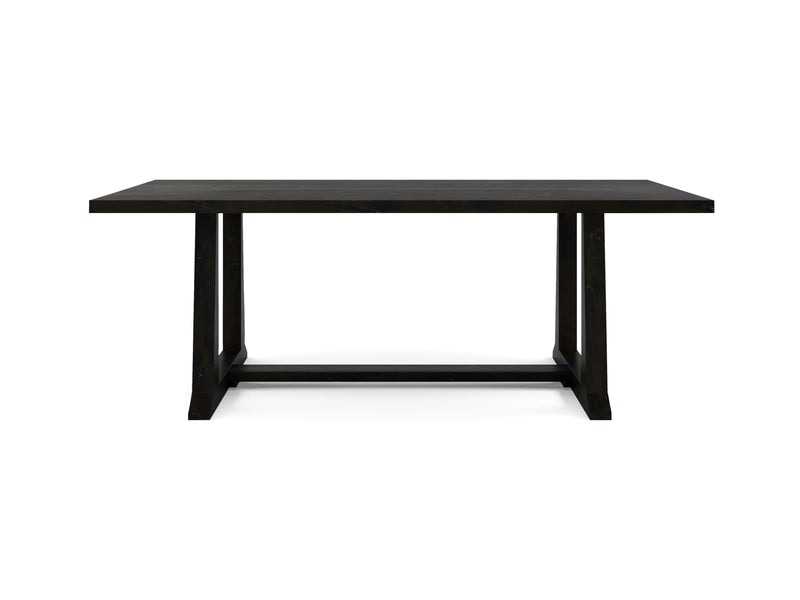 The Cora Dining Table - Charred Ember by James+James is a rectangular black wooden table featuring a flat top and sturdy legs connected by horizontal supports. It showcases a minimalist design and is centered on a white background.