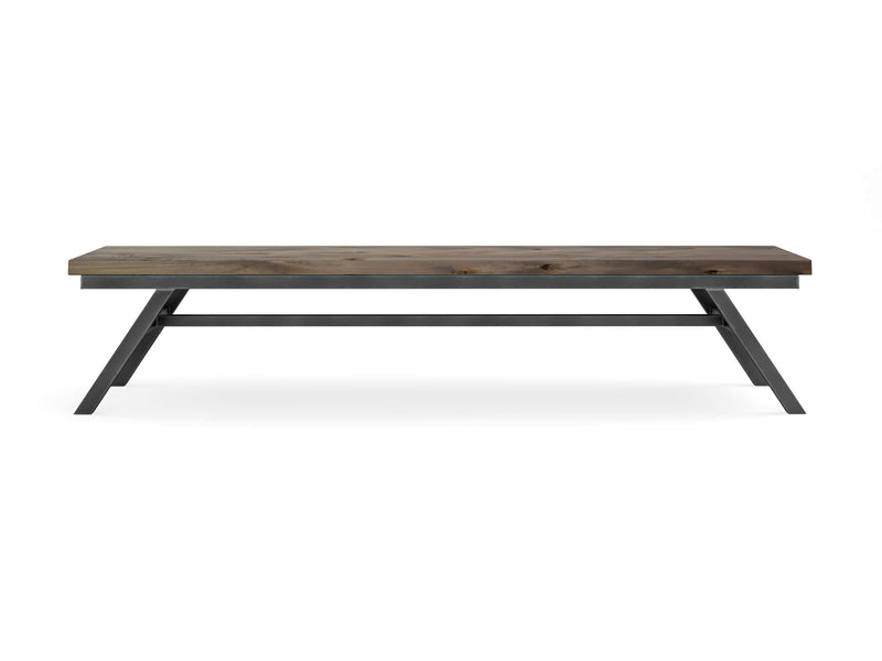 The James+James Fulton Bench - Barn Wood boasts a minimalist design with a rectangular wooden top featuring a natural, weathered finish and angled black metal legs. For added stability, the design includes a crossbar. This bench exudes a modern, industrial aesthetic and is showcased against a white background.