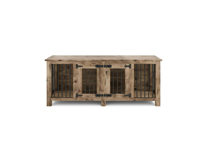 The Double Dog Kennel - Harvest Wheat by James+James is a rectangular wooden dog crate with a rustic finish. It features two metal-barred doors with black hinges and latches on the front. The crate has a smooth flat top that can also function as a table surface, and its design ensures adequate ventilation.