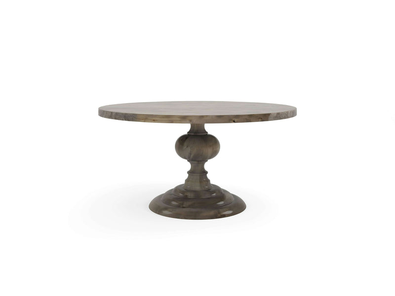 The Josephine Round Dining Table - Barn Wood by James+James is a rustic round wooden table with a light brown finish. It features a smooth top surface and a single, sturdy pedestal base with a carved, bulbous design, ending in a wide, rounded bottom for support. The background is plain white.