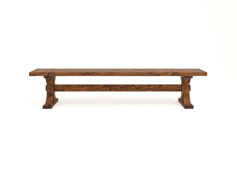 The Trestle Bench - Tuscany by James+James is a rustic wooden bench with a dark brown finish. It features a simple, sturdy design with solid legs and a flat seat. The visible wood grain enhances its natural and rugged appearance, set against a white background.