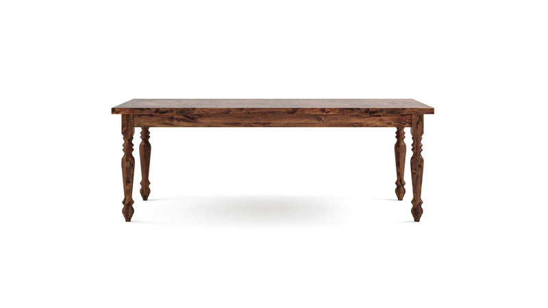 The James+James French Country Dining Table - Tuscany features a polished wooden surface and intricate, carved legs. With its rustic, vintage appearance, this rectangular table is photographed against a plain white background.