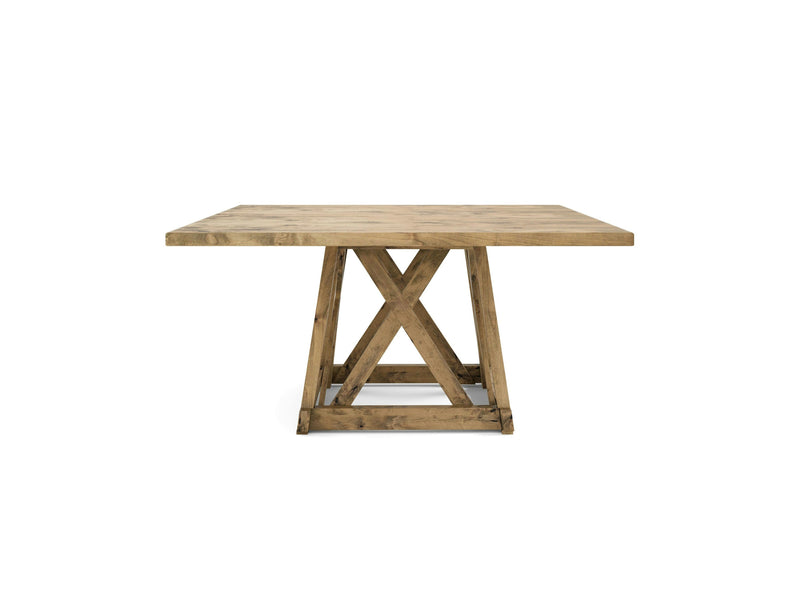 The Julia Square Dining Table - Harvest Wheat by James+James is a rustic wooden table with a square top and a sturdy base featuring an X-shaped design. The wood has a natural finish, highlighting its grain and texture. The overall style is simple yet robust, suitable for a variety of settings.