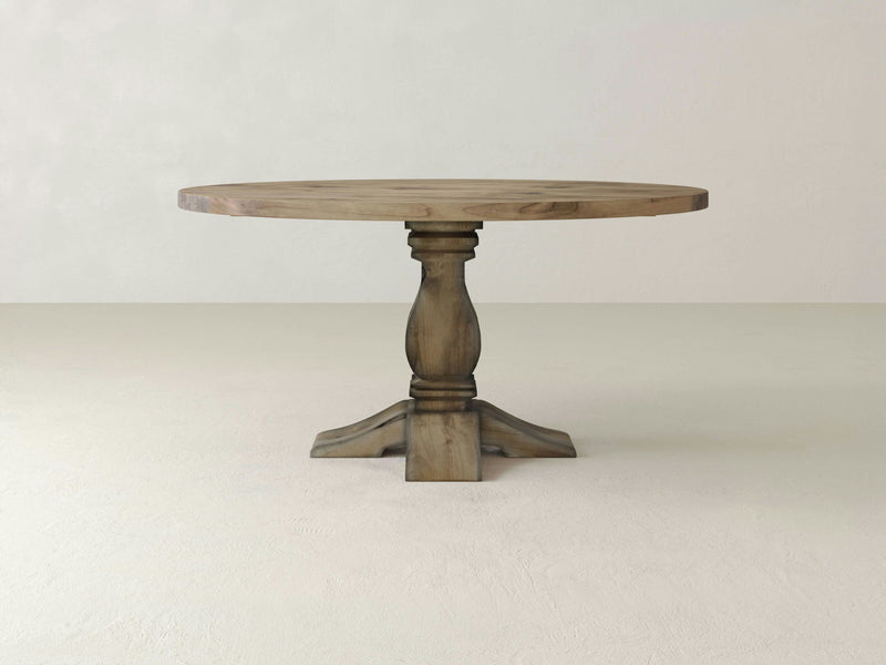 Close-up of the polished surface of the Heirloom Round Dining Table - Harvest Wheat by James+James, featuring a natural knot and grain patterns. The wood showcases a light, warm tone with subtle color variations that highlight its natural texture and organic imperfections. The table's edge possesses a smooth, beveled finish.