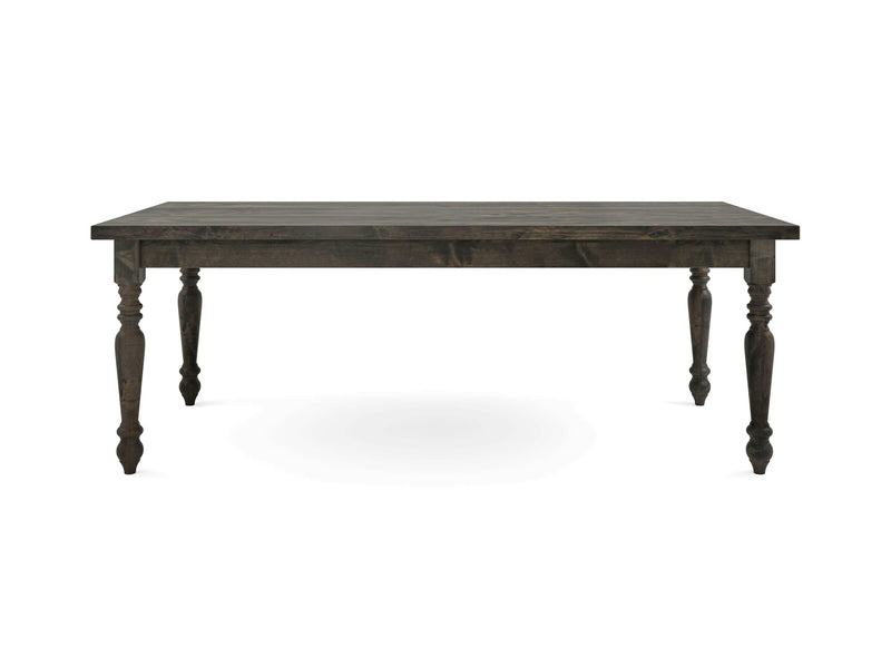 A French Country Dining Table - Deep Grey from James+James with a dark wooden rectangular surface and four intricately carved legs. The table features a rustic finish and a robust appearance, making it suitable for dining or other uses. The plain white background enhances the table's detailed craftsmanship.