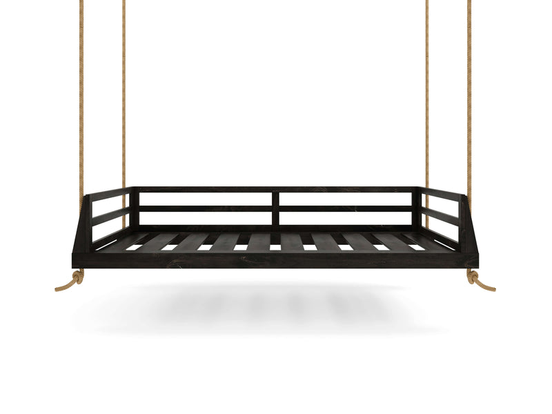 The Piper Porch Swing - Charred Ember by James+James is a black wooden hanging swing with a slatted base and side rails, suspended from thick ropes, set against a white background.