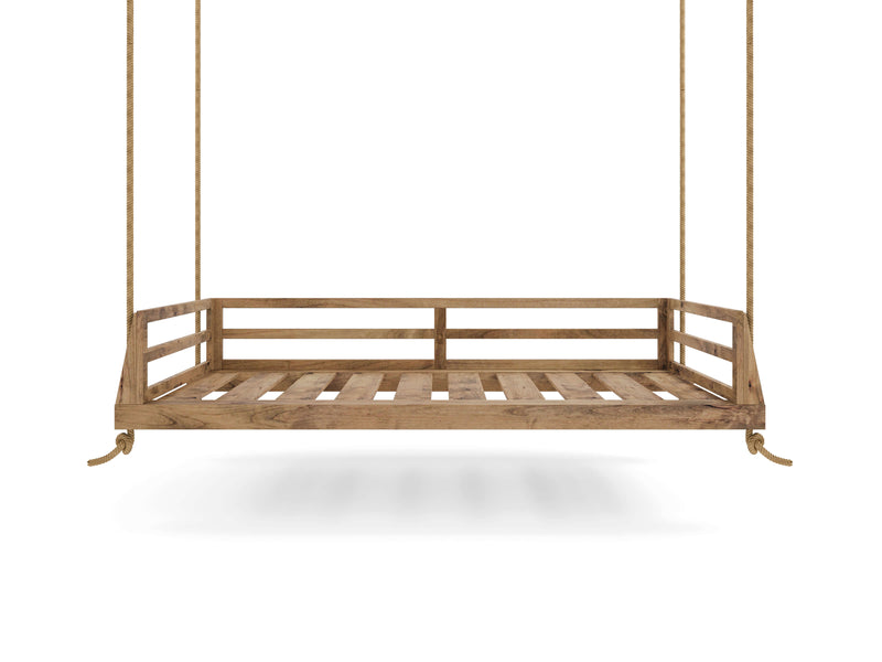 The Piper Porch Swing - Harvest Wheat by James+James, a wooden swing bed hanging from ropes, features a slatted design bed frame with three side railings, leaving the front open. The swing is suspended in mid-air against a plain white background.