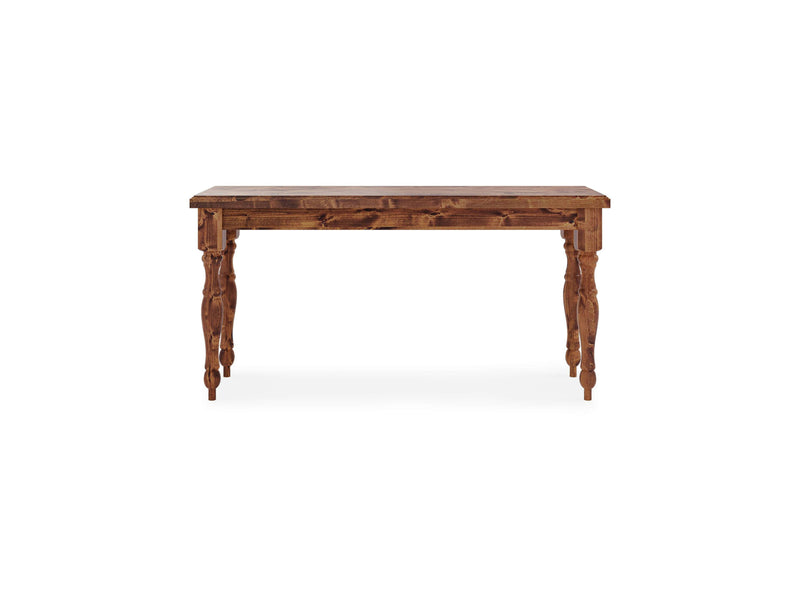 The Abigail Sofa Table - Tuscany by James+James is a wooden table with an antique finish, featuring intricately carved legs and a smooth rectangular top. The table has a rustic appearance, showcasing the natural wood grain and detailed craftsmanship. The background is plain white.