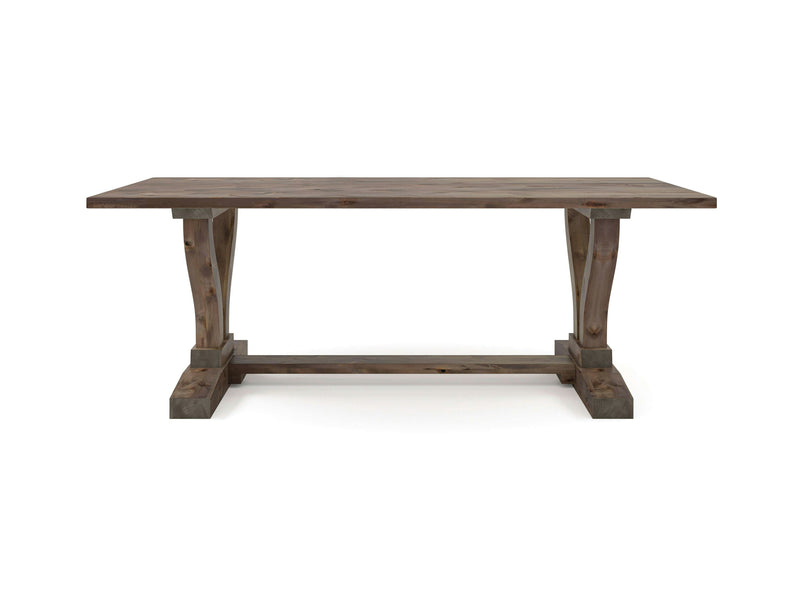 The Vera Dining Table - Barn Wood by James+James features a rectangular top supported by two sturdy, curved legs connected by a horizontal crossbar. The weathered, natural finish of the barn wood gives the table an antique look, while its wide, flat feet ensure stability.