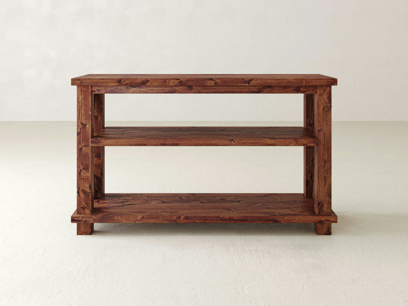 A Carter X Sofa Table - Tuscany by James+James with x-shaped shelves.