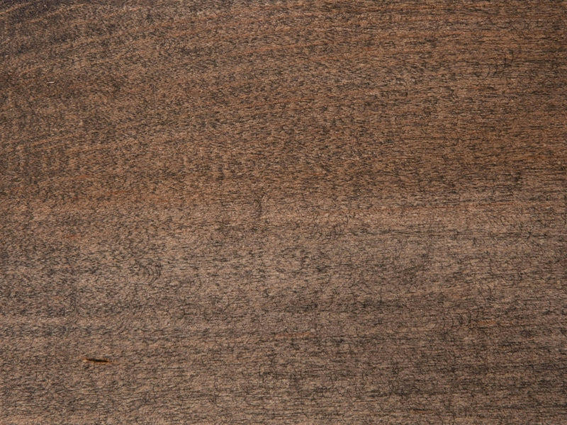 A close-up view of a Maple surface finished in Deep Grey by James+James, displaying a natural grain pattern. The wood has a deep, rich hue with subtle variations in tone, showcasing its textured and slightly weathered appearance.