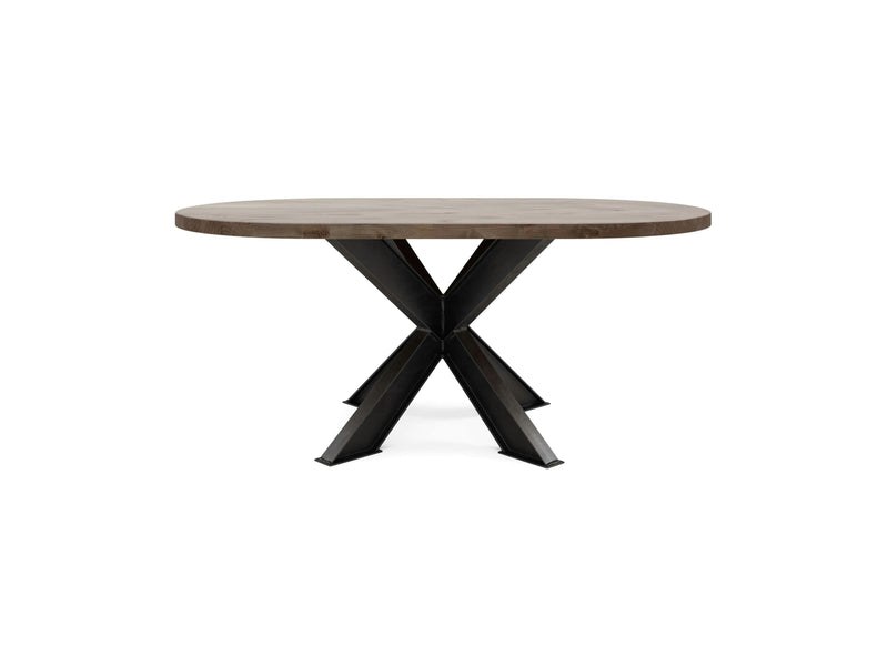 The Shiloh Oval Dining Table - Barn Wood from James+James features a robust top and industrial-style black metal legs that intersect at the base, creating an X shape. Its sleek and modern design makes it an ideal addition as a dining table or accent piece in various settings.