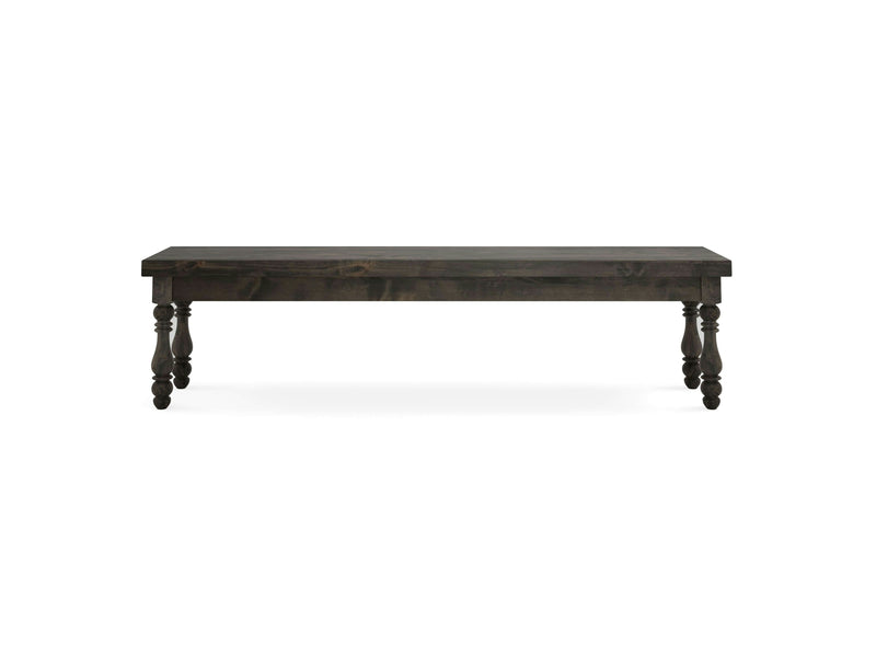 The Annli Bench - Deep Grey by James+James features a dark wooden, rectangular seat supported by four ornate, rounded legs. The bench showcases a smooth top surface and a simple, classic design. It is set against an isolated white background.