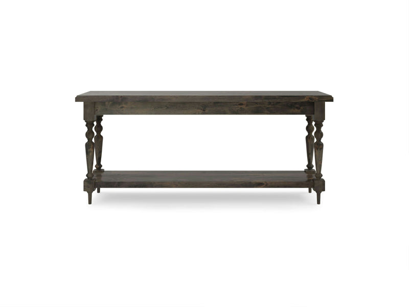 The Ella Sofa Table in Deep Grey is a rectangular console table from James+James, featuring turned legs and a lower open shelf for extra storage space. With its classic and elegant design, it complements various interior styles. The table is showcased against a plain white background.