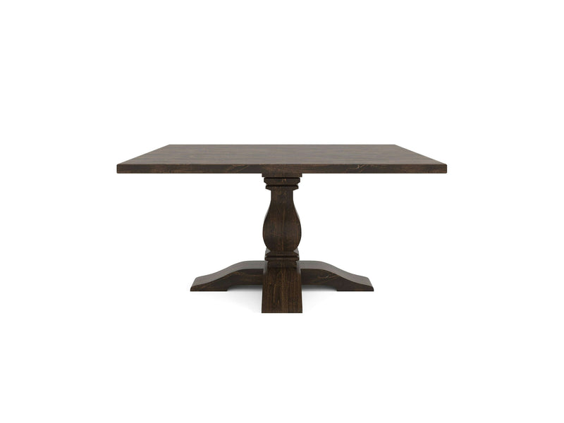 The Heirloom Square Dining Table - Tobacco, by James+James, features a rectangular wooden top and a central pedestal base. The pedestal boasts a square column that elegantly flares out into four curved legs at the bottom. The wood is dark-stained with a sleek, smooth finish.