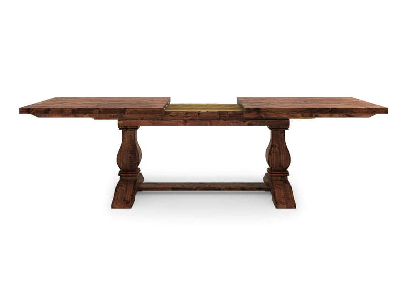 The Heirloom Expandable Dining Table - Tuscany by James+James is a wooden dining table with a dark finish, featuring two rectangular leaves extended on either side. The table has two ornate pedestal legs connected by a horizontal stretcher bar and an extendable central section.