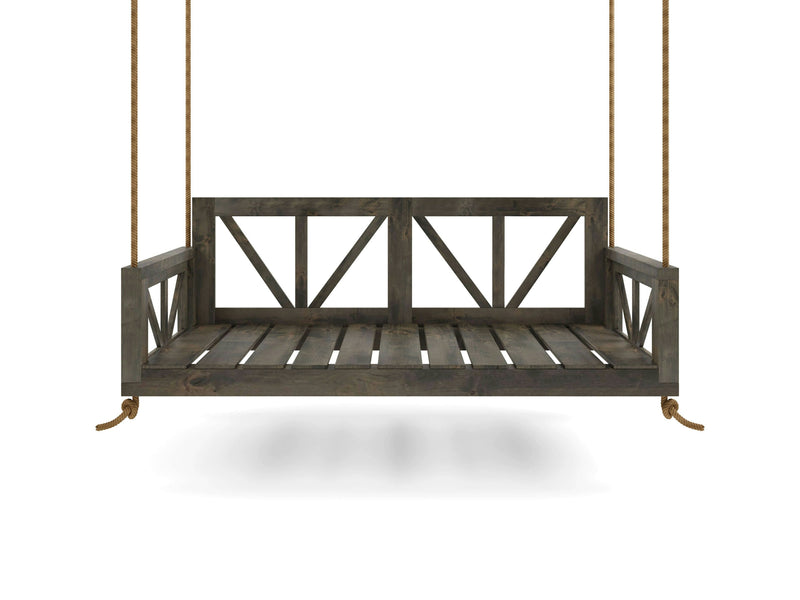 The Avery Porch Swing - Deep Grey by James+James features a wooden bench with a backrest adorned with a simple X-pattern design. It is suspended by sturdy, thick ropes and appears to be floating against a plain white background, casting a faint shadow below.