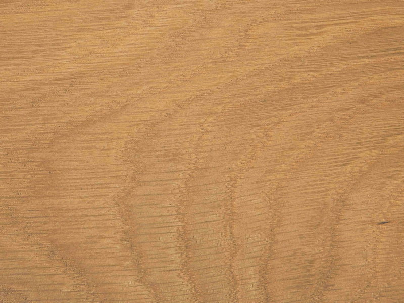 A close-up view of the James+James Satin on White Oak Sample showcasing a natural grain pattern with wavy lines and varying shades of light brown.