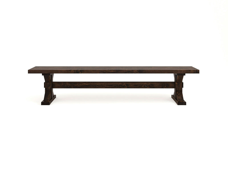 The James+James Trestle Bench - Tobacco features a dark wooden rectangular seat supported by sturdy legs and a crossbar for added stability. Its simple yet rustic design is highlighted against a plain white background, showcasing the bench's clean lines and craftsmanship.