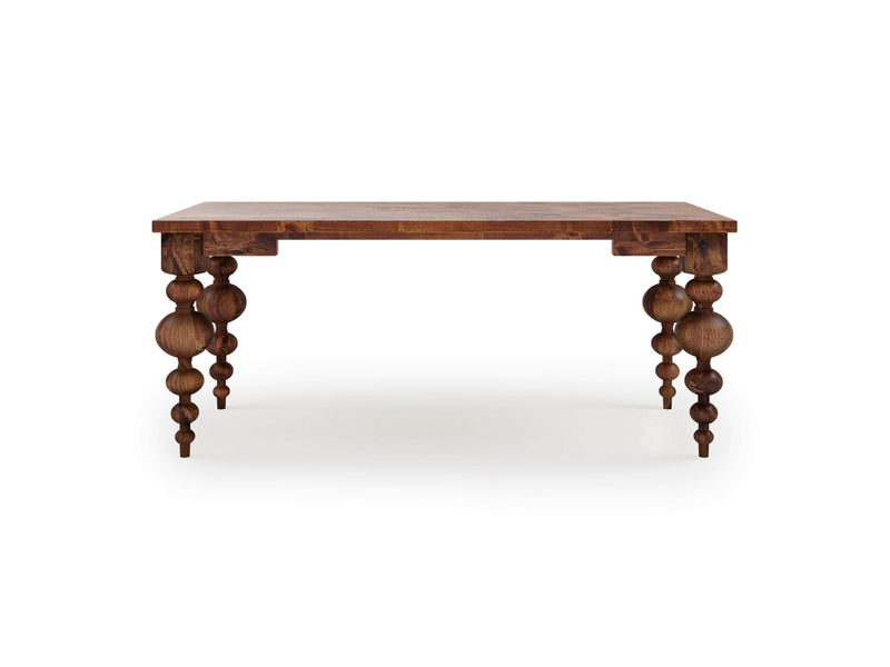 Introducing the Olivia Desk - Tuscany by James+James, a stunning wooden desk with ornate, sculpted legs showcasing a series of rounded and tapered shapes, including multiple spheres. The rectangular tabletop is plain, allowing the intricate design of the legs to take center stage. This exquisite piece is set against a white background.