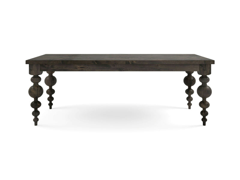 The Olivia Dining Table - Deep Grey by James+James is a dark wooden table with four intricately carved legs featuring spherical and spiral designs. The rectangular, flat tabletop has a rustic finish. The background is plain white.