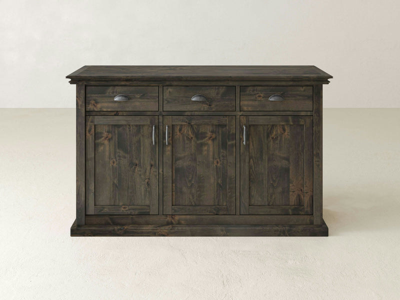 The Nora Buffet in Deep Grey by James+James stands against a plain, light-colored background. This dark wooden sideboard features three drawers with handle pulls at the top and three cabinet doors with metal handles below, showcasing a simple design.