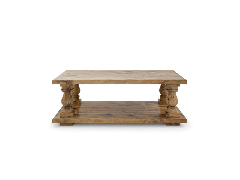 The Vivien Coffee Table in Harvest Wheat by James+James is a rectangular wooden coffee table with a rustic finish, featuring a thick top and bottom shelf. It boasts four ornate, carved legs connecting the two shelves, providing both sturdiness and decorative appeal.