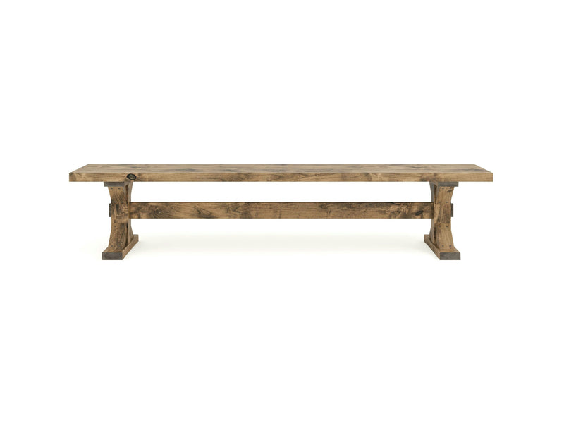 The Trestle Bench - Harvest Wheat from James+James is a wooden bench featuring a rectangular seat with a sturdy, rustic design. It has two solid legs connected by a horizontal support beam underneath. The wood is light brown with visible grain patterns, giving it a natural, handcrafted appearance.