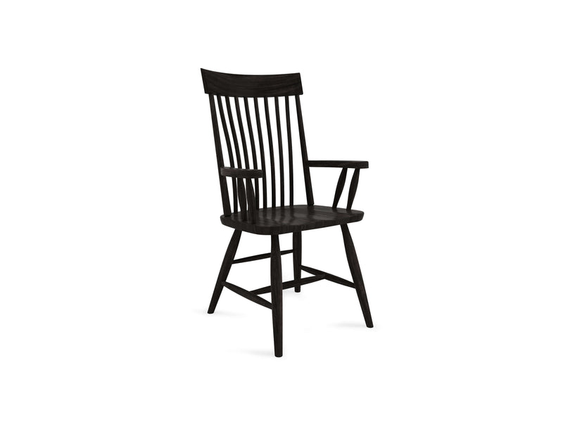 The Eleanor Arm Dining Chair - Charred Ember by James+James features a dark wooden finish, a high, slatted backrest, and slightly curved armrests. It stands on four tapered legs and boasts a contemporary rustic design that seamlessly blends traditional and modern aesthetics. The solid seat offers sturdy support.