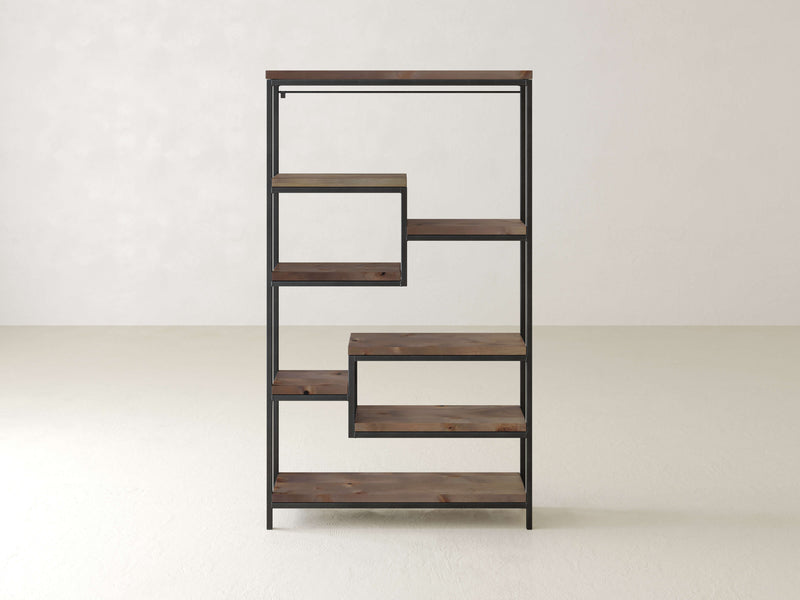 The Arlo Shelf by James+James features industrial steel and solid hardwood shelves, boasting a modern, minimalist design with a black metal frame and a staggered, step-like arrangement. It sits elegantly in an empty room with light-colored walls and flooring.