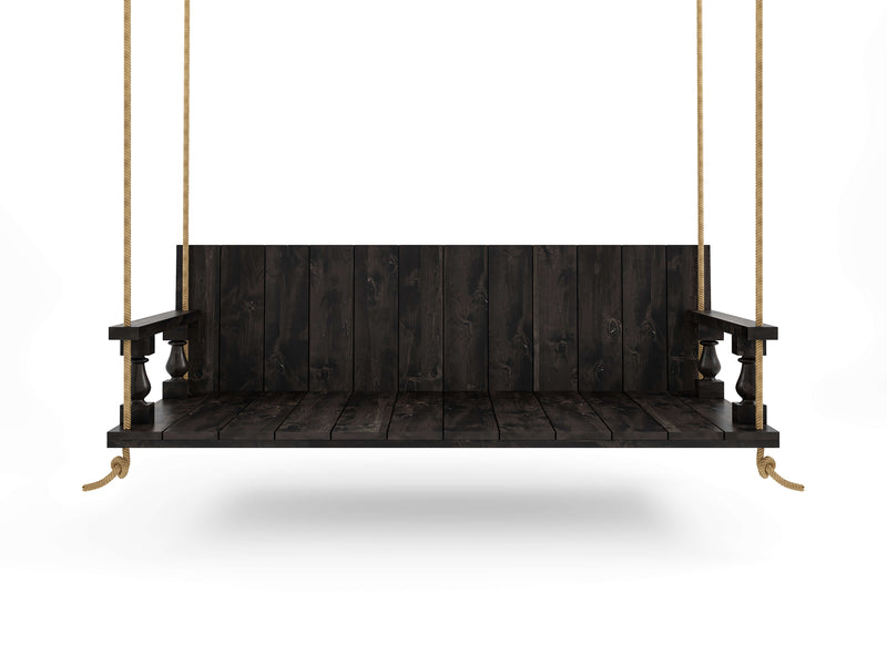 The Maisie Porch Swing - Charred Ember by James+James, featuring a dark wooden finish with a backrest and armrests, hangs from ropes against a plain white background. Its simple, rustic design highlights the wood grain texture and robust construction.