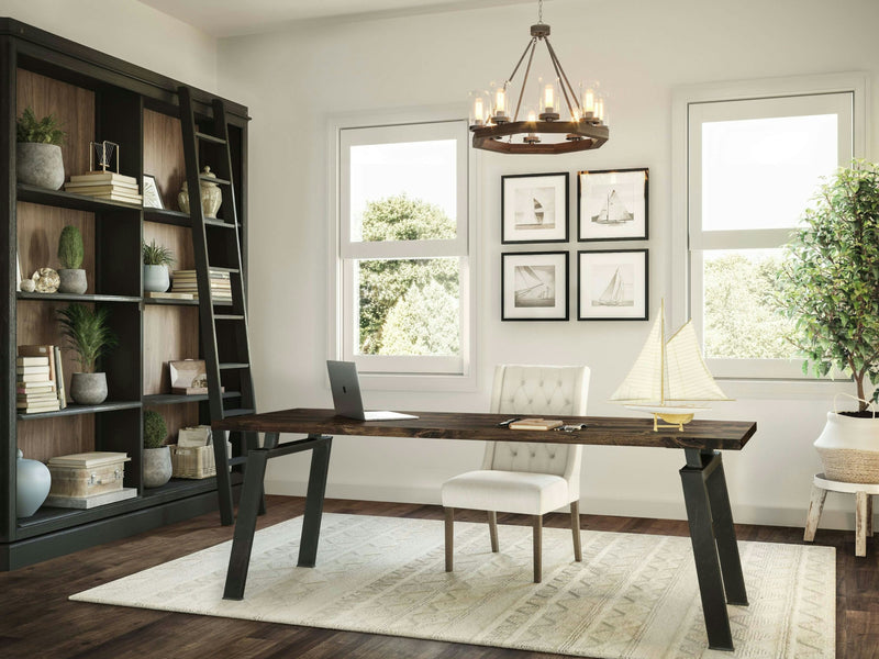 The Fulton Desk - Tobacco by James+James features a close-up view of its wooden surface, showcasing rich, dark brown hues and natural grain patterns. The wood exhibits an abstract, almost wavy texture with lighter areas that accentuate the intricate details of the grain.