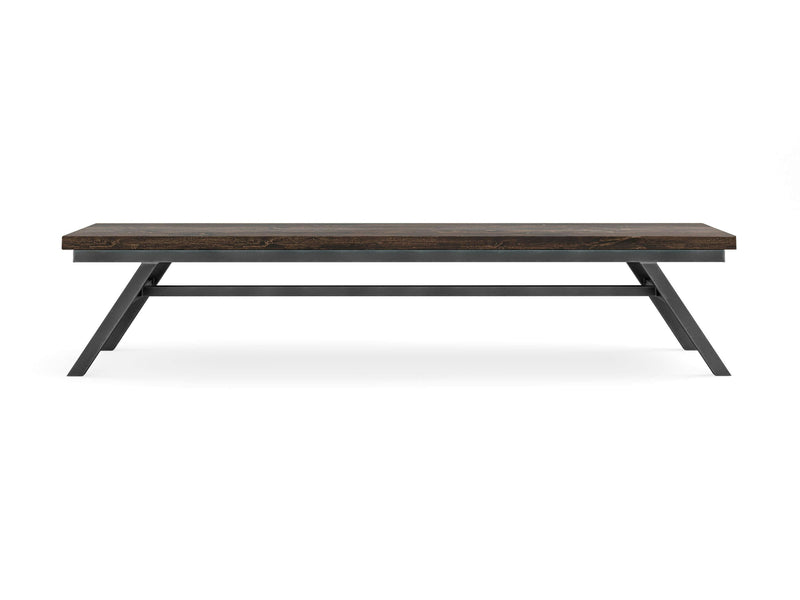 A rectangular wooden bench named the Fulton Bench - Tobacco by James+James features a dark wooden top and angled black metal legs. The design is minimalist and modern, with a sturdy frame and a smooth surface. The bench is placed against a white background.