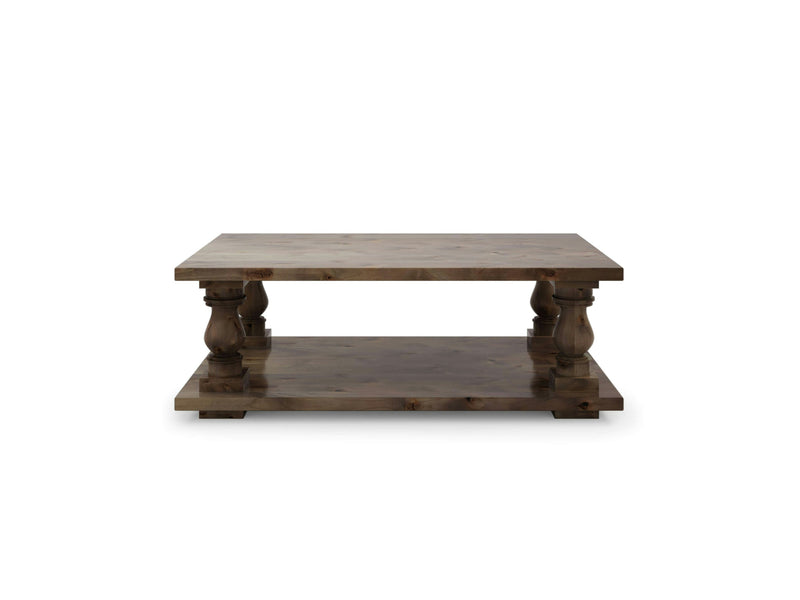 The Vivien Coffee Table by James+James is a rectangular piece made from barn wood, showcasing a rustic finish with thick edges and four turned legs. This coffee table includes a lower shelf for extra storage, embodying a simple yet functional design with a classic and timeless appeal.