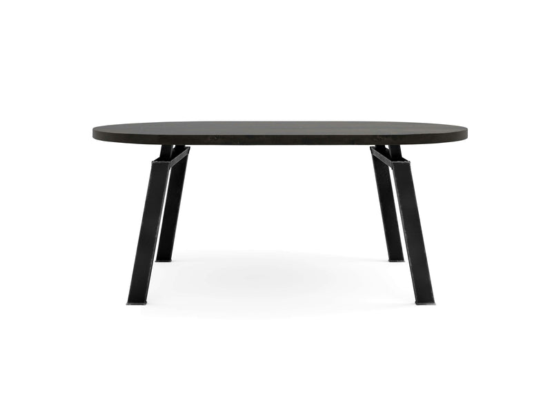 The Fulton Oval Dining Table - Charred Ember by James+James features a sleek, dark oval tabletop supported by four black, angled legs. This modern table boasts a minimalist design that provides a contemporary aesthetic suitable for various spaces. The industrial-style legs enhance the overall appearance, making it a versatile addition to any room.