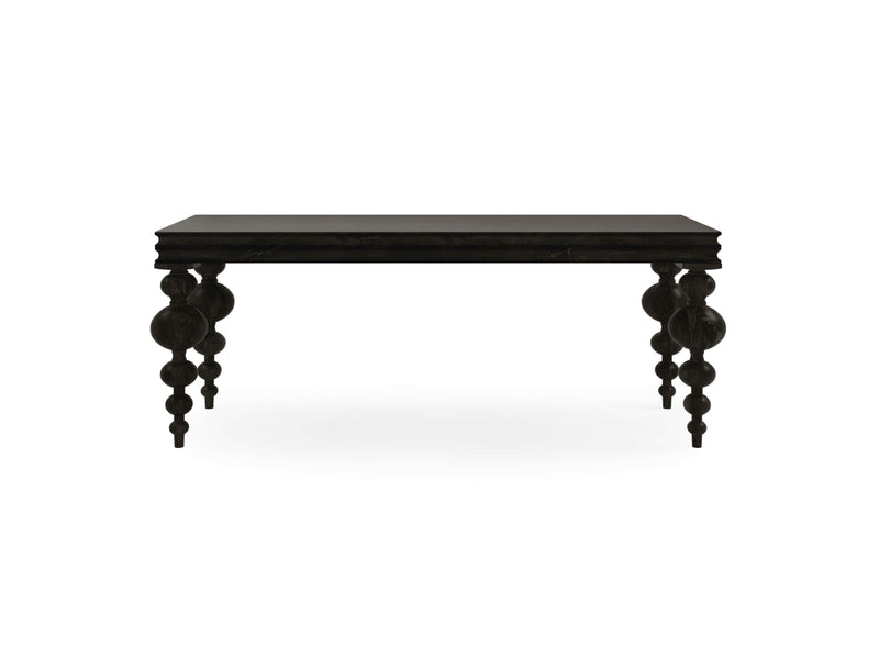 The Olivia Sofa Table - Charred Ember by James+James is a black rectangular table with intricately sculpted, rounded legs. The table boasts a dark, elegant appearance, and the legs feature a unique, ornamental design that enhances its decorative style. The background is plain white.