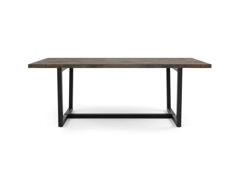 The Trapezoid Dining Table - Deep Grey by James+James features a rectangular wooden top with a deep grey finish, supported by a sleek black metal frame. Its simple, modern design boasts clean lines and a robust construction, making it ideal for both dining and workspace purposes. The metal frame includes a crossbar at the base for enhanced stability.