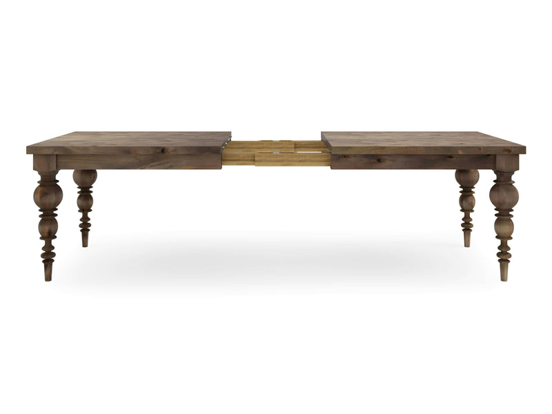 The Bailey Expandable Dining Table - Barn Wood by James+James features ornate, turned legs and a rustic finish. This wooden dining table includes an extendable leaf insert in the center, with the middle section retracted to reveal the mechanism for extending the table.