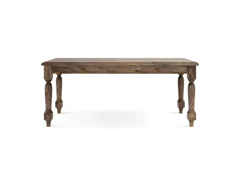 The Rosemary Desk by James+James is a rectangular wooden table featuring a smooth, flat surface and four sturdy, intricately carved legs. The barn wood shows off a natural finish with visible grains that lend a rustic appearance. The desk is set against a plain white background.